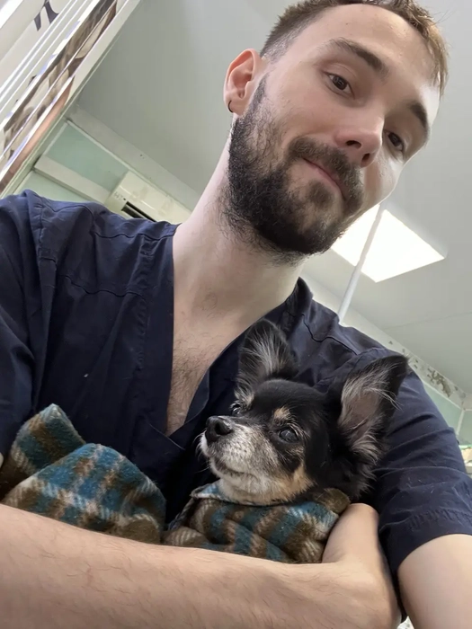 Dr. Strelkov holding a dog during a clinic visit